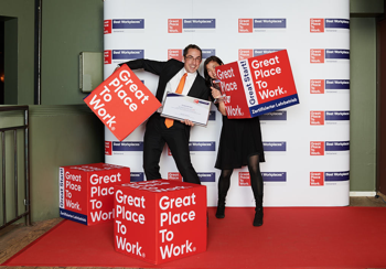 Our employees are taking pictures with the "Great Place To Work" Cube - happy about the award.