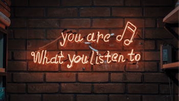 A brick wall with the neon sign "You are what do you listen to" underlines that audio is becoming more and more important. 