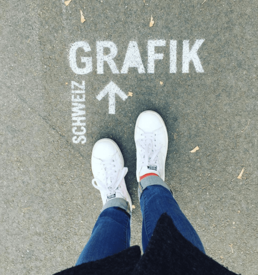 Our colleague is attending this year's conference pointing towards a large sign on the street saying "Grafik Schweiz". 