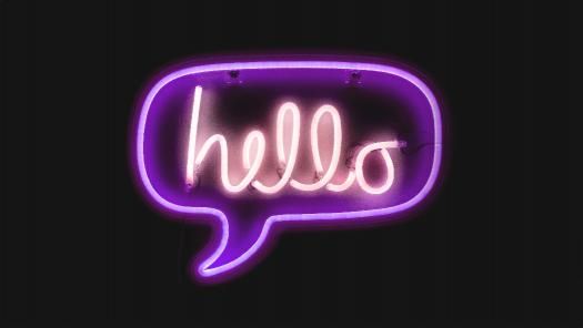 Neon letters forming the word "Hello" in a speech bubble.