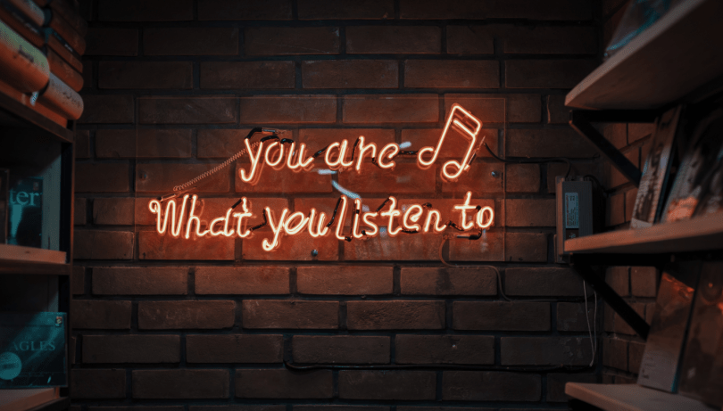 A brick wall with the neon sign "You are what do you listen to" underlines that audio is becoming more and more important. 